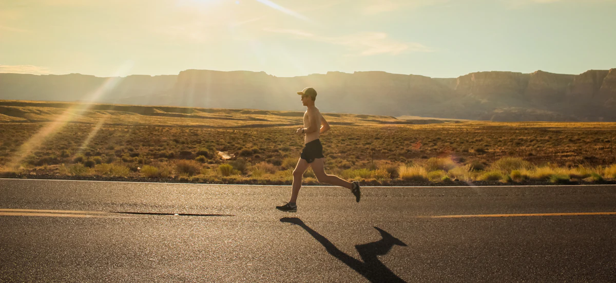 Runner on an open road at golden hour