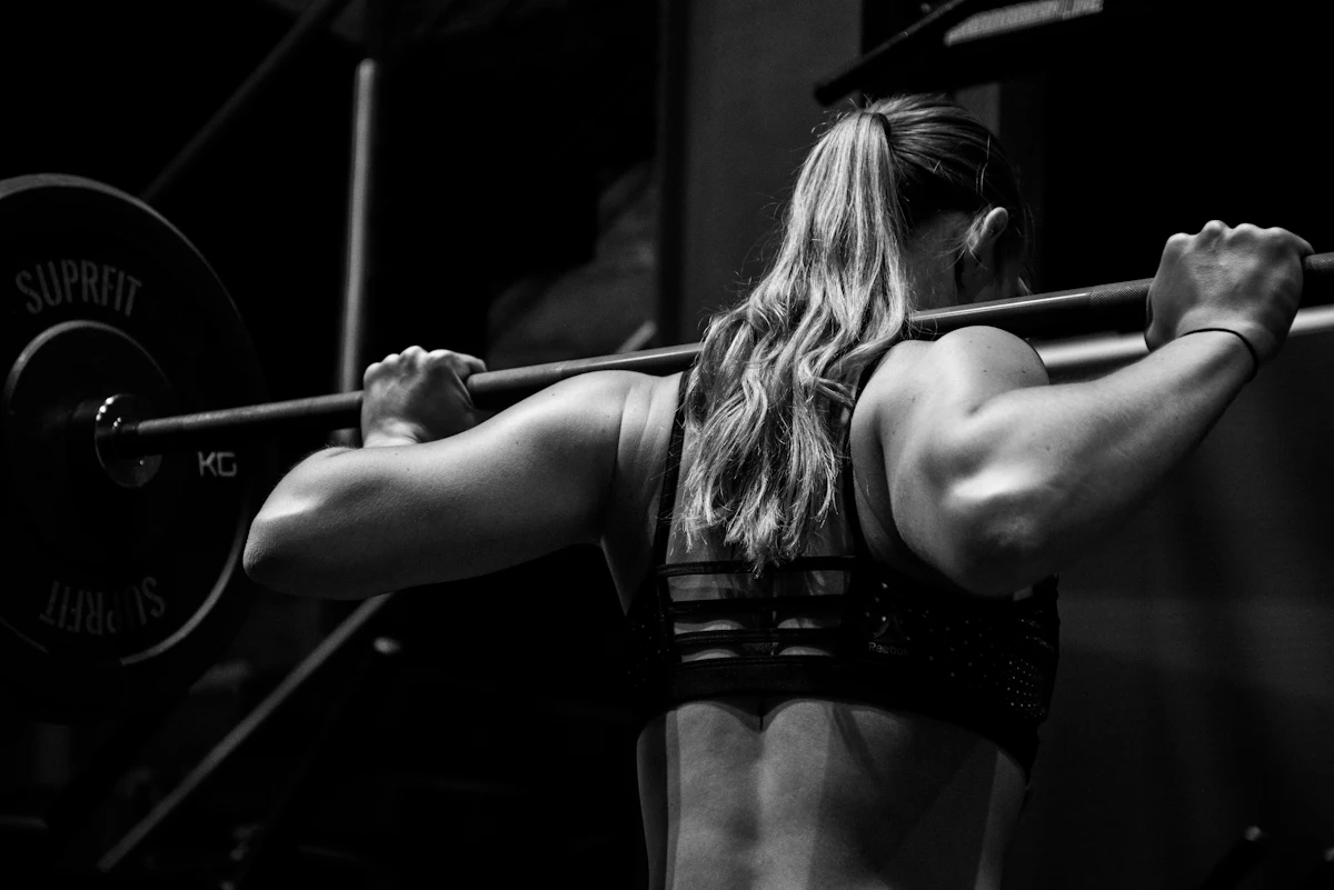 Athlete with a barbell across her back